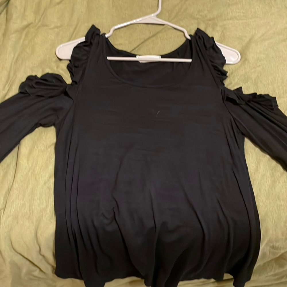Black long sleeve T-shirt. Ruffles on shoulders with shoulder cut out.